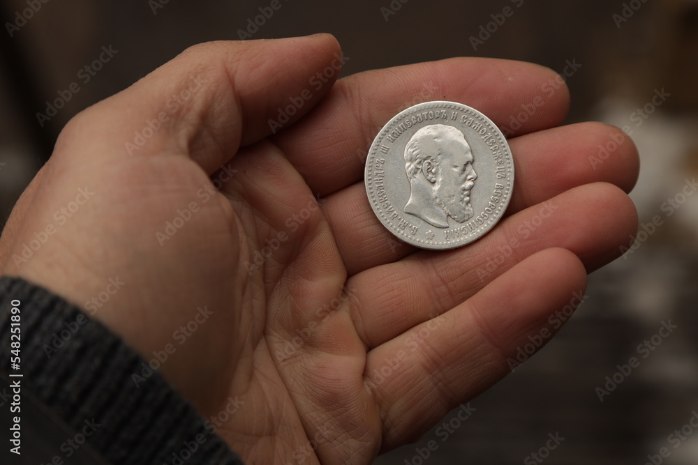 Silver coin of Russian Empire one ruble in hand Silver coin of Russian Empire one ruble in hand