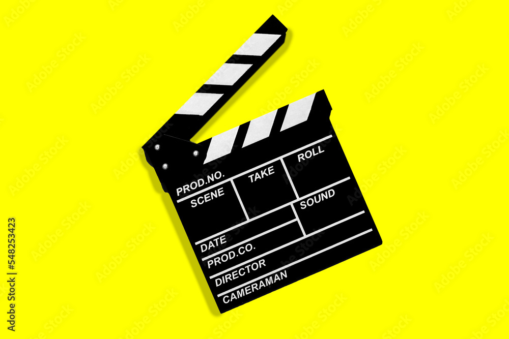 Clapperboard for shooting video footage takes on a yellow background