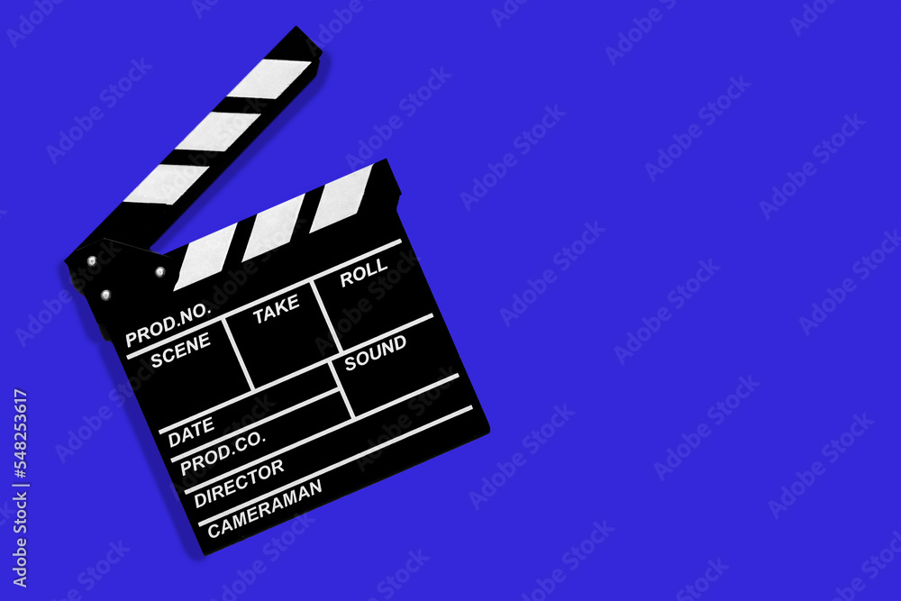 Movie clapperboard for shooting videos and movies on a blue background copy space