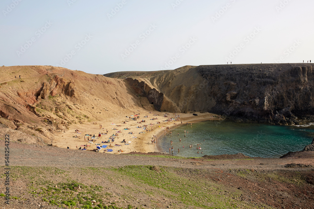 Amazing landscape of wild sandy beach surrounded by volcanic cliffs Amazing landscape of wild sandy beach surrounded by volcanic cliffs
