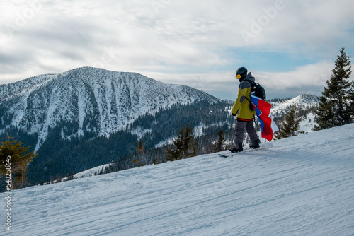 man snowboarder with slovakia flag at ski resort slope