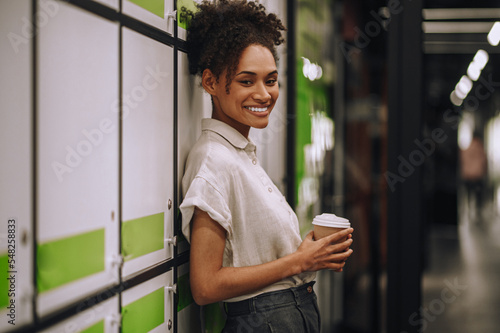Female employee posing for the camera during the coffee break