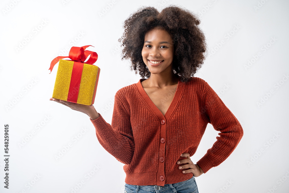 Portrait of young attractive african american woman with curly hair presenting gift box in studio on white background. Portrait of young attractive african american woman with curly hair presenting gift box in studio on white background.
