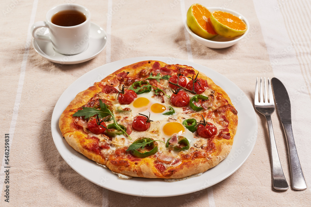breakfast pizza with eggs, cup of coffee and oranges breakfast pizza with eggs, cup of coffee and oranges