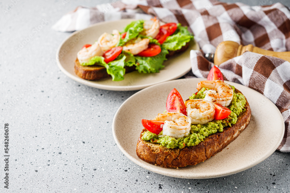 delicious Italian bruschetta with shrimps on a gray stone background