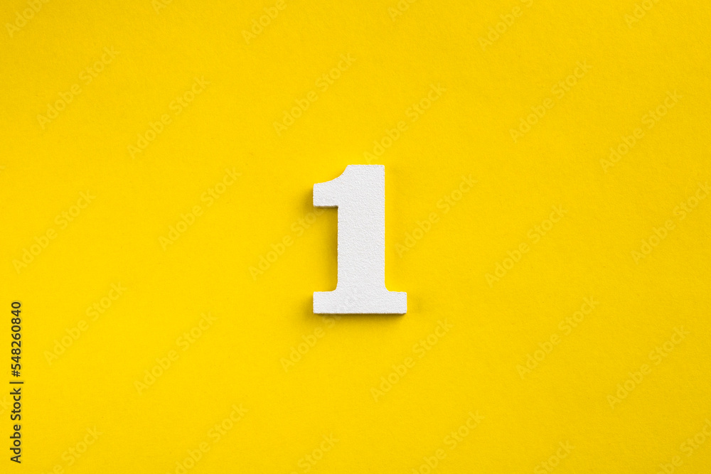 Number one - white number in wood on yellow background - obrazy, fototapety, plakaty 