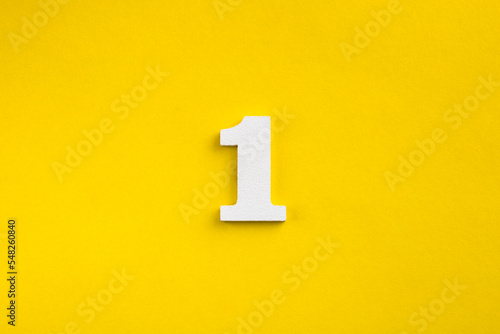 Number one - white number in wood on yellow background