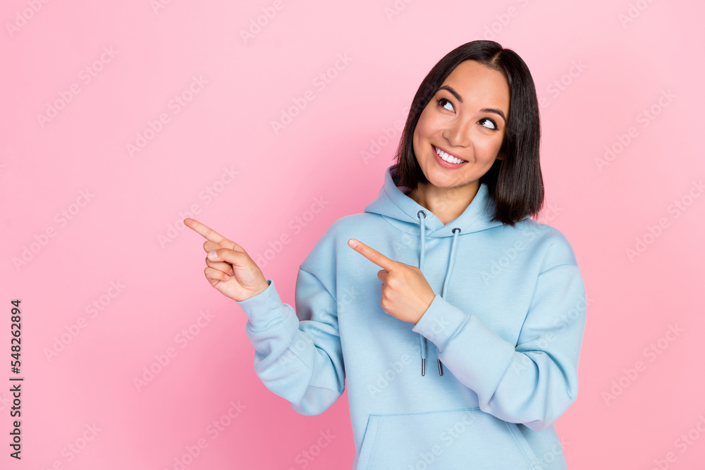 Photo portrait of cute young lady point empty space look dreamy thoughtful wear trendy blue garment isolated on pink color background Photo portrait of cute young lady point empty space look dreamy thoughtful wear trendy blue garment isolated on pink color background