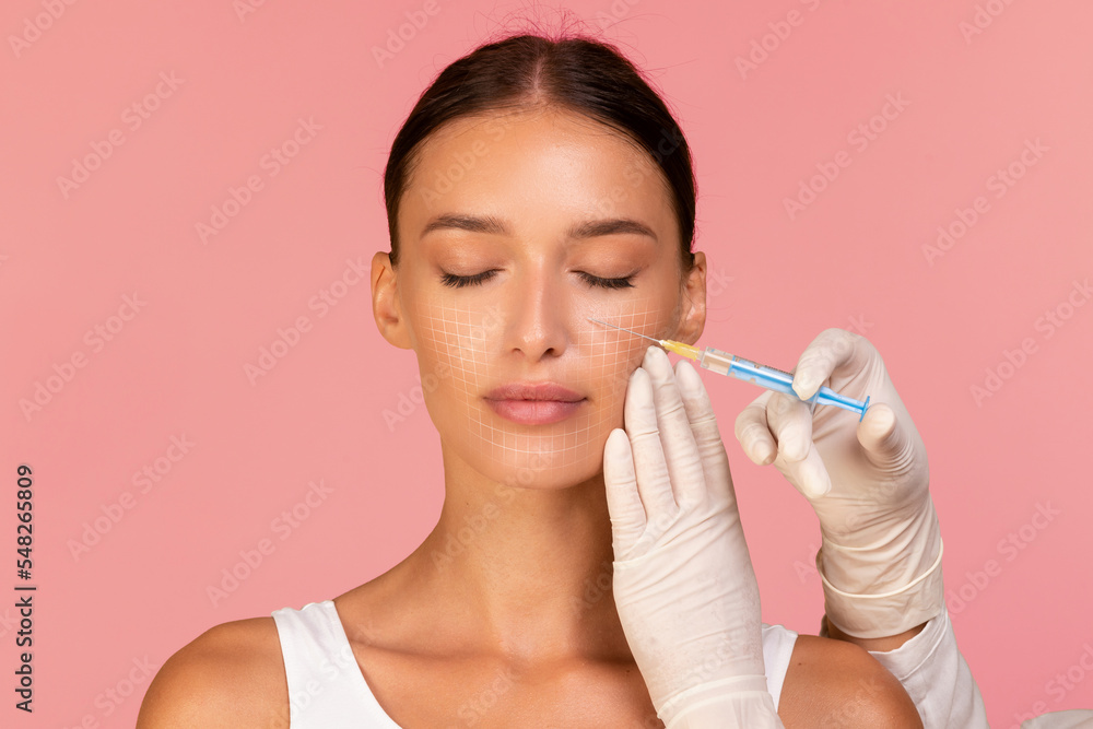 Beautician Doctor Making Injection To Beautiful Woman With Drawn Mesh On Face