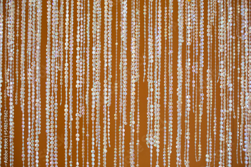 crystal bead curtain on a yellow background photo
