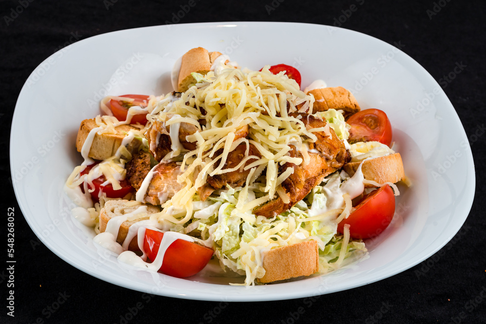 Fresh Caesar salad with chicken, parmesan cheese, lettuce, tomatoes and croutons. Fresh Caesar salad with chicken, parmesan cheese, lettuce, tomatoes and croutons.