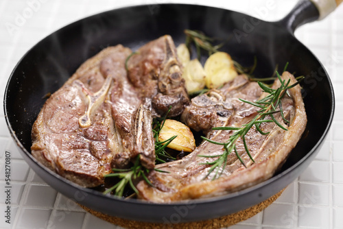 lamb shoulder chop steaks on a skillet
 photo