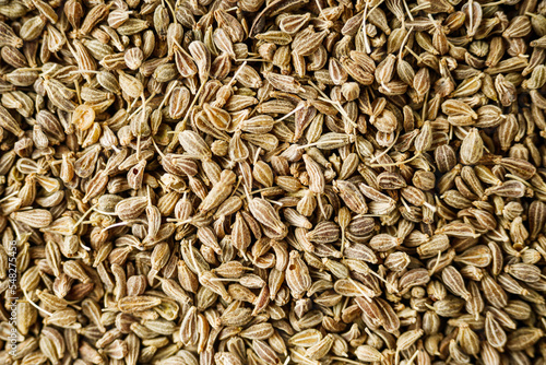 aromatic dry anise seeds on a dark black stone background