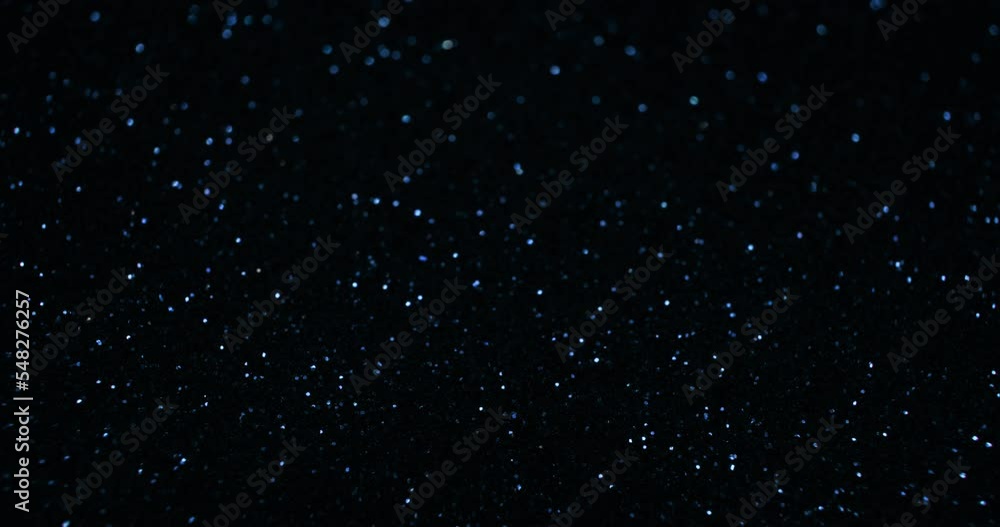 Sparkling background. Bokeh glitter texture. Defocused blue color twinkling light circles on dark night black abstract free space. Shot on RED Cinema Camera. Sparkling background. Bokeh glitter texture. Defocused blue color twinkling light circles on dark night black abstract free space. Shot on RED Cinema Camera.