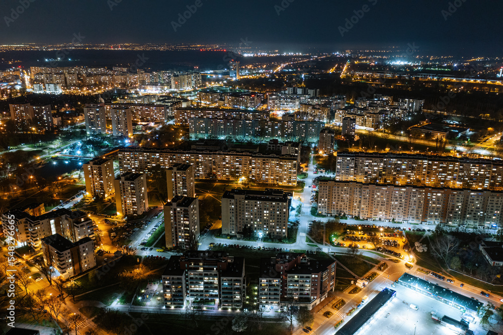 Warsaw by night, aerial landscape of illuminated streets and buildings