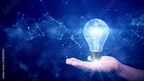 business idea creative concept technology. Illuminated light bulb and connected polygons above hand on dark blue background.