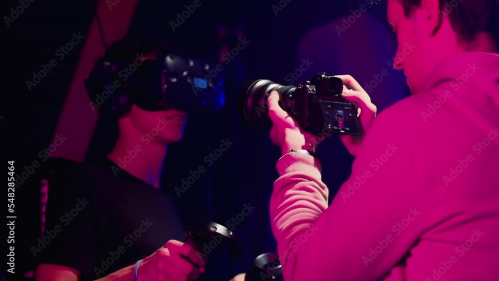 Shooting video with VR games in a studio with blue pink neon lights Shooting video with VR games in a studio with blue pink neon lights