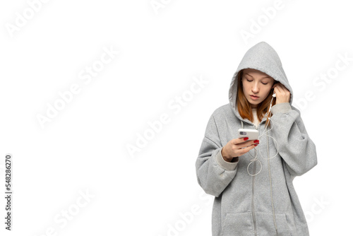 Obraz na płótnie Cool ginger teenager girl in depression. Wear hoodie, listen to music on smartphone, putting on headphones sad young woman png isolated Adolescence social problems of growing up. w salonie