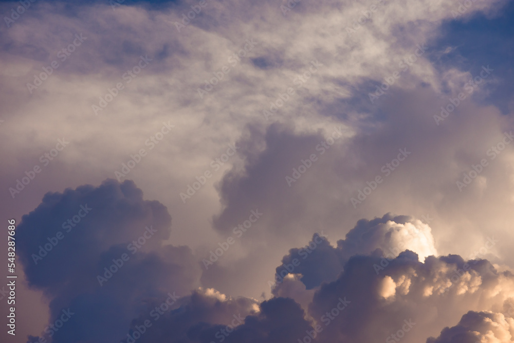Random colorful clouds formation against dramatic sky. Calm and tranquil backdrop during sunrise or sunset