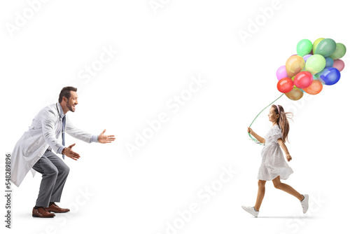 Full length profile shot of a girl with balloons running towards a doctor