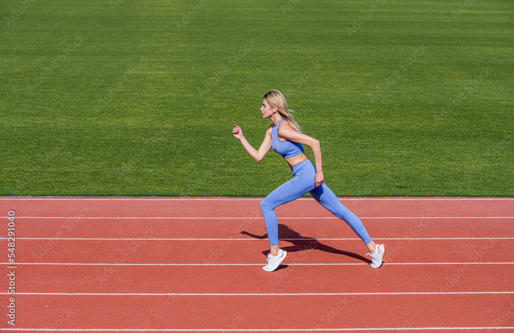 Professional sportswoman during running training session. Woman on stadium track. Sportswoman wearing sportswear. Sportswoman, sportswear. Sportswoman exercising in sport clothing, training, workout