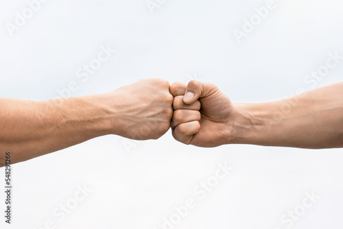 Teamwork and friendship. Partnership concept. Man giving fist bump. Bumping fists together. Fist Bump. Clash of two fists. Concept of confrontation, competition. Gesture of giving respect or approval