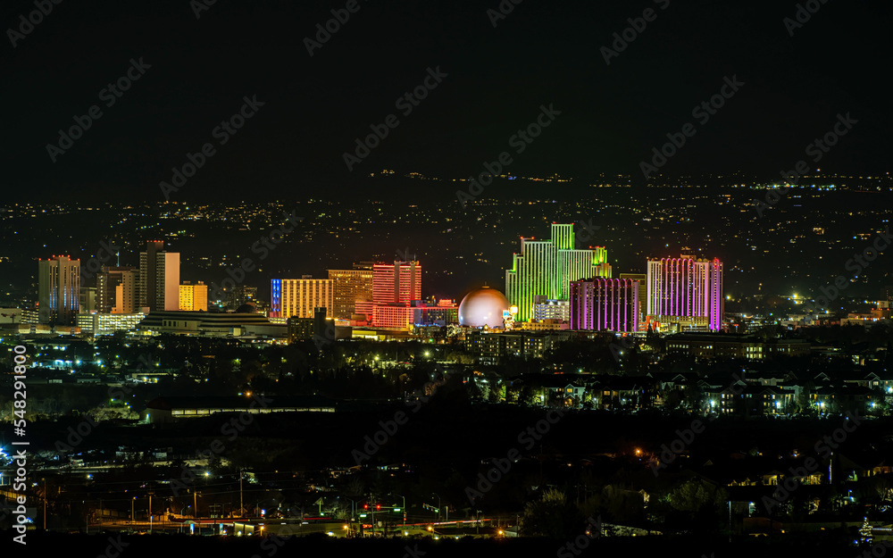 Fototapeta premium City of Reno Nevada skyline at night with Hotels, casinos and the surrounding urban area