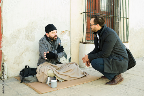 Concerned man chatting about helping a homeless man