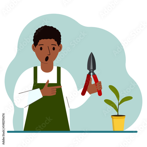 A gardener is a man in working clothes, he has a pruner in his hand.