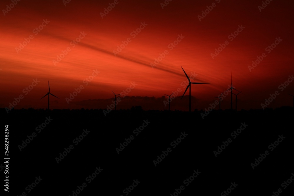 Fototapeta premium Landscape with windmills in the sunset 