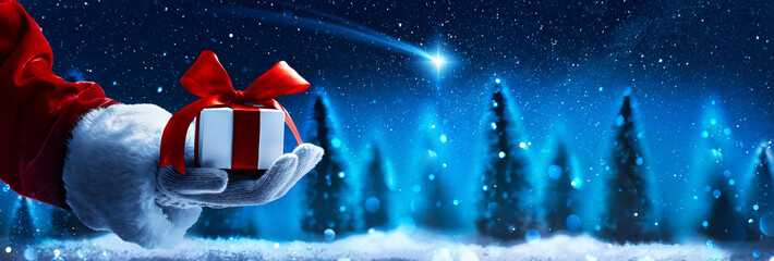 Christmas present from Santa Claus. Night starry sky with falling Christmas star