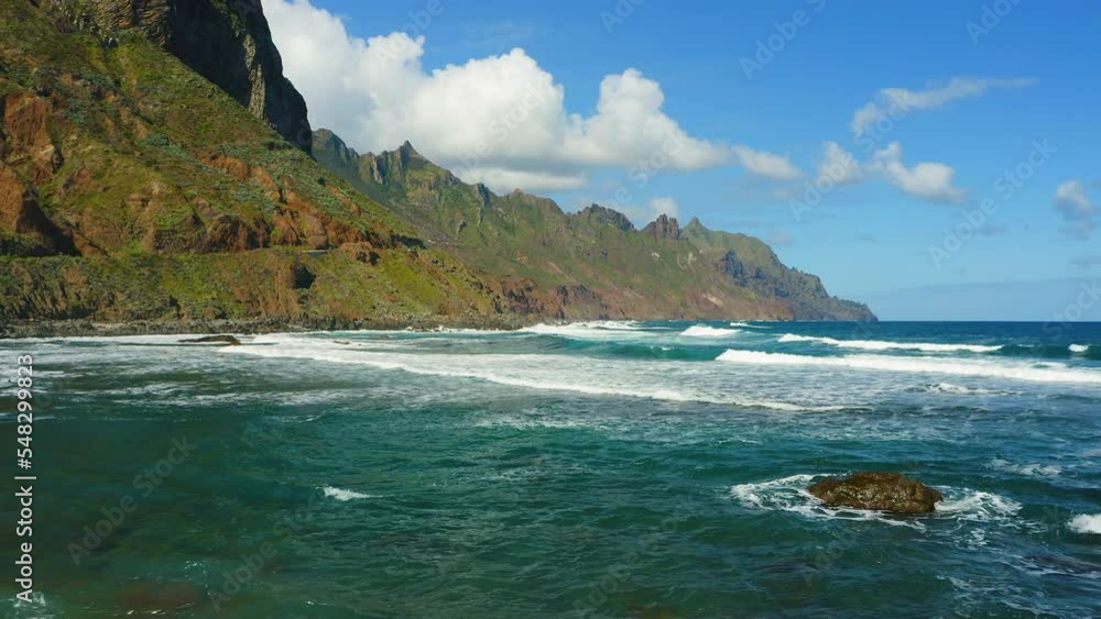 Relax blue ocean view on mountain range silhouette background. Aerial sea beach waves foam on empty sandy shore backlit. Beautiful nature landscape in its original form. Relax blue ocean view on mountain range silhouette background. Aerial sea beach waves foam on empty sandy shore backlit. Beautiful nature landscape in its original form.