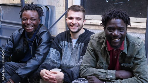 multiethnic smiles - witty guys of different ethnicity laugh at camera