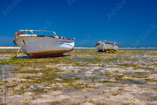 Photography Beautiful view of the boat in the bay of the Mediterranean Sea at low tide on th