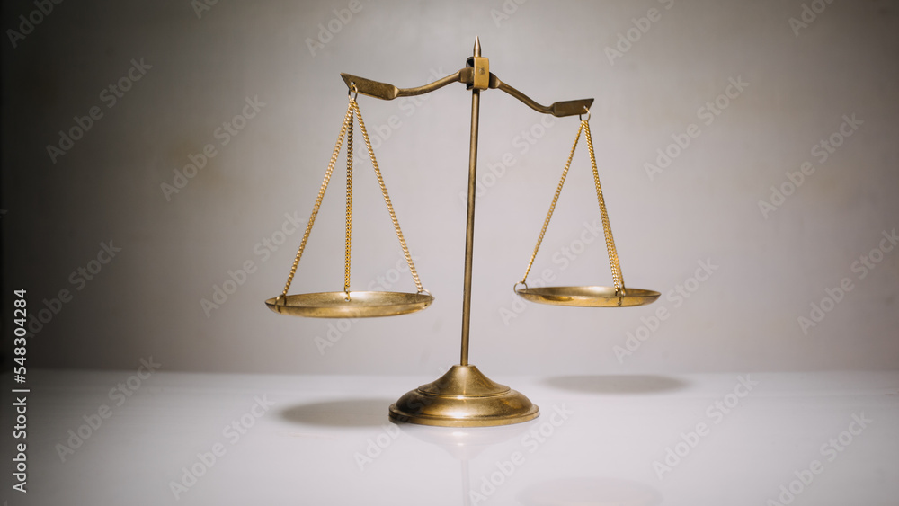 Business and lawyers discussing contract papers with brass scale on desk in office. Law, legal services, advice, justice and law concept Business and lawyers discussing contract papers with brass scale on desk in office. Law, legal services, advice, justice and law concept