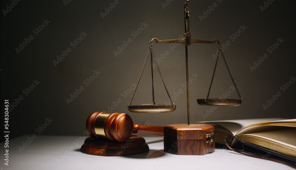 Business and lawyers discussing contract papers with brass scale on desk in office. Law, legal services, advice, justice and law concept