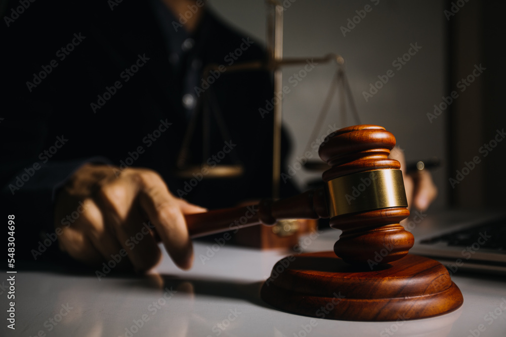 Business and lawyers discussing contract papers with brass scale on desk in office. Law, legal services, advice, justice and law concept Business and lawyers discussing contract papers with brass scale on desk in office. Law, legal services, advice, justice and law concept