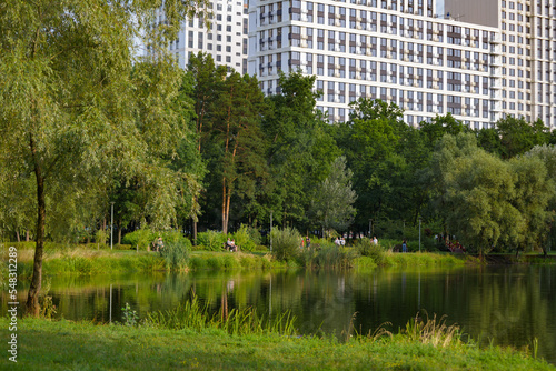 Park, lake inside urban area. Summer. Walking green area. Summer, sunset.