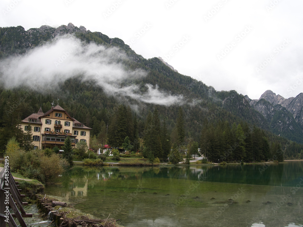 Fototapeta premium Autumn morning after the rain by the lake of Dobbiaco(Toblacher See). South Tyrol, province of Bolzano. Dolomites, Italy.