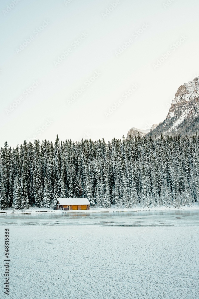 Isolated Cabin on Ice in Snowy Mountains