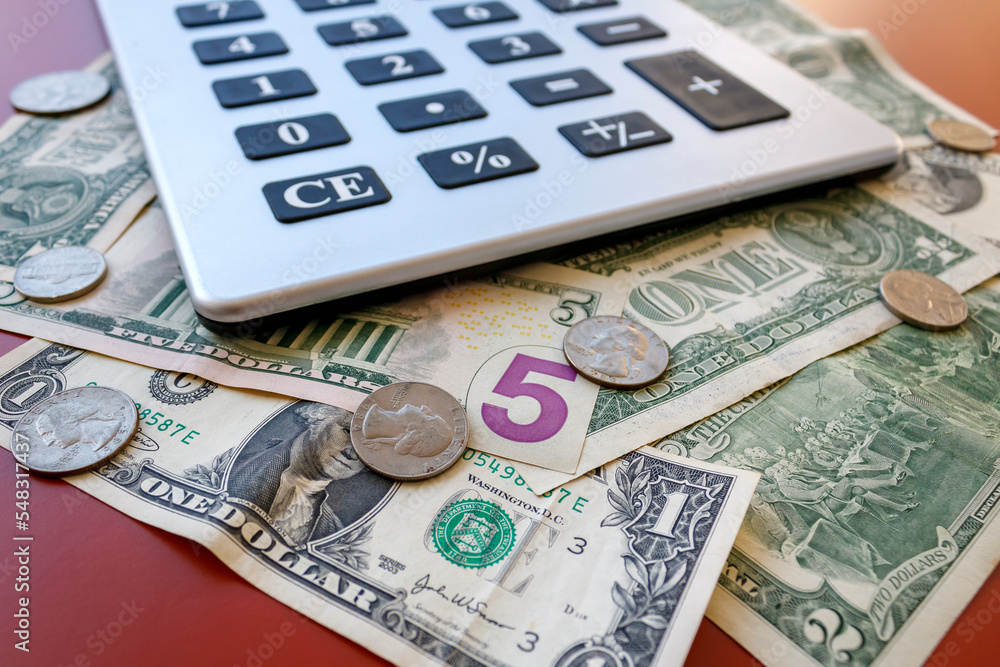 Close-up of American money - coins and banknotes - with calculator Close-up of American money - coins and banknotes - with calculator