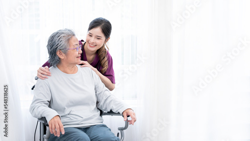 Medical staff taking and caregiver senior woman in Home. Home care concept.