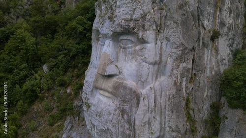 Aerial video of the statue of Decebal, located on the gorges of Danube river in Romania. Video was shoot from a drone with camera lowered with the statue in the view.