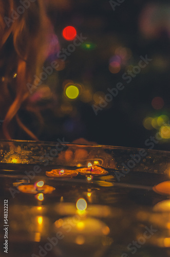 symbolic christmas tradition with candles in nutshell floating on water, © katarinagondova