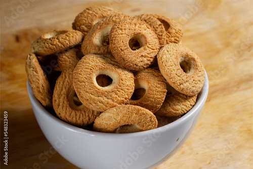 Ring Coconut biscuits served in a bowl. Brazilian little donut. Selective focus.