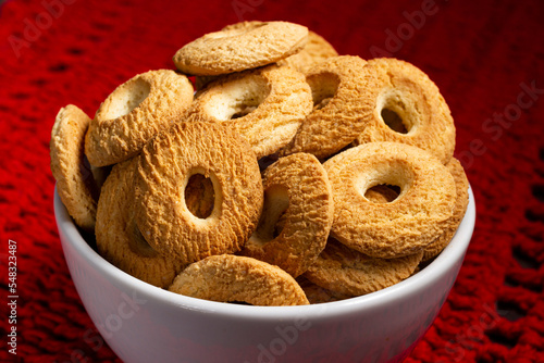 Ring Coconut biscuits served in a bowl. Brazilian little donut. Selective focus.