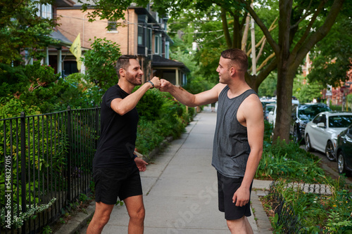 Men bumping fists after exercising.
