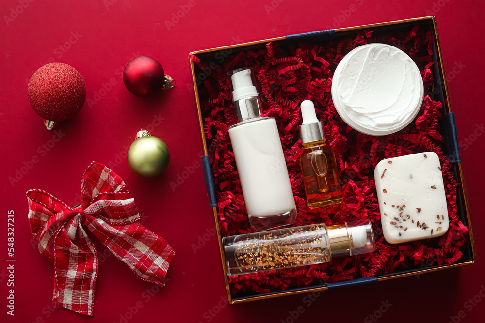 Christmas gift set, xmas holidays beauty box subscription package and  luxury skincare products flatlay, cosmetic flat lay on red background,  cosmetics as holiday present or shopping delivery, top view Stock Photo