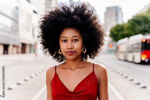 Beautiful young black woman outdoors in the city - Afro american cheerful female adult portrait © oneinchpunch