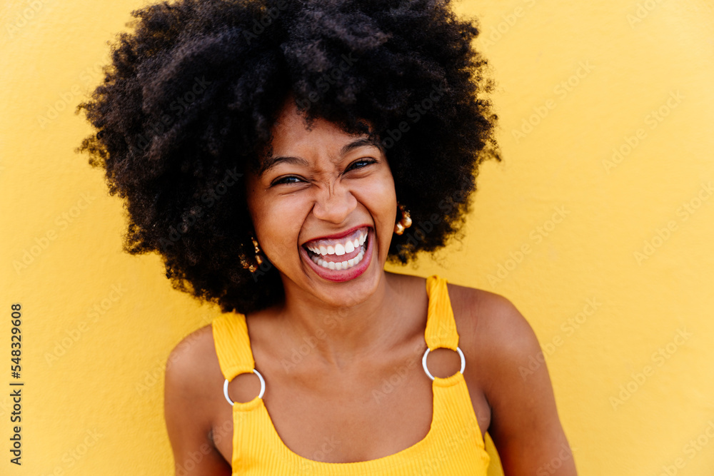Beautiful young black woman outdoors in the city - Afro american cheerful female adult portrait Beautiful young black woman outdoors in the city - Afro american cheerful female adult portrait